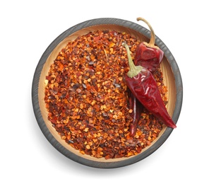 Photo of Plate with crushed chili pepper and pods on white background