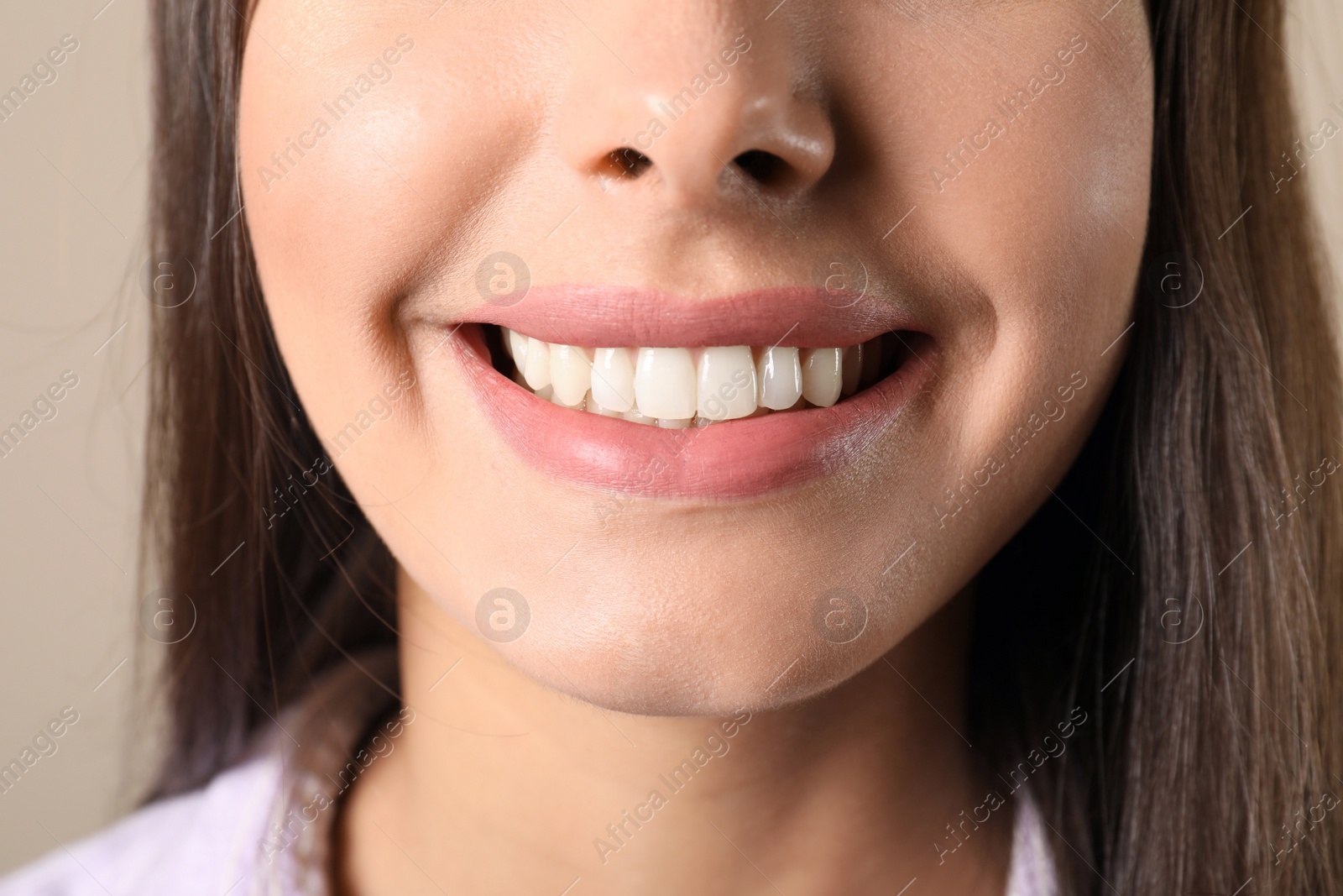 Photo of Young woman with healthy teeth on color background, closeup