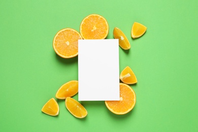 Photo of Flat lay composition with ripe oranges and space for text on color background