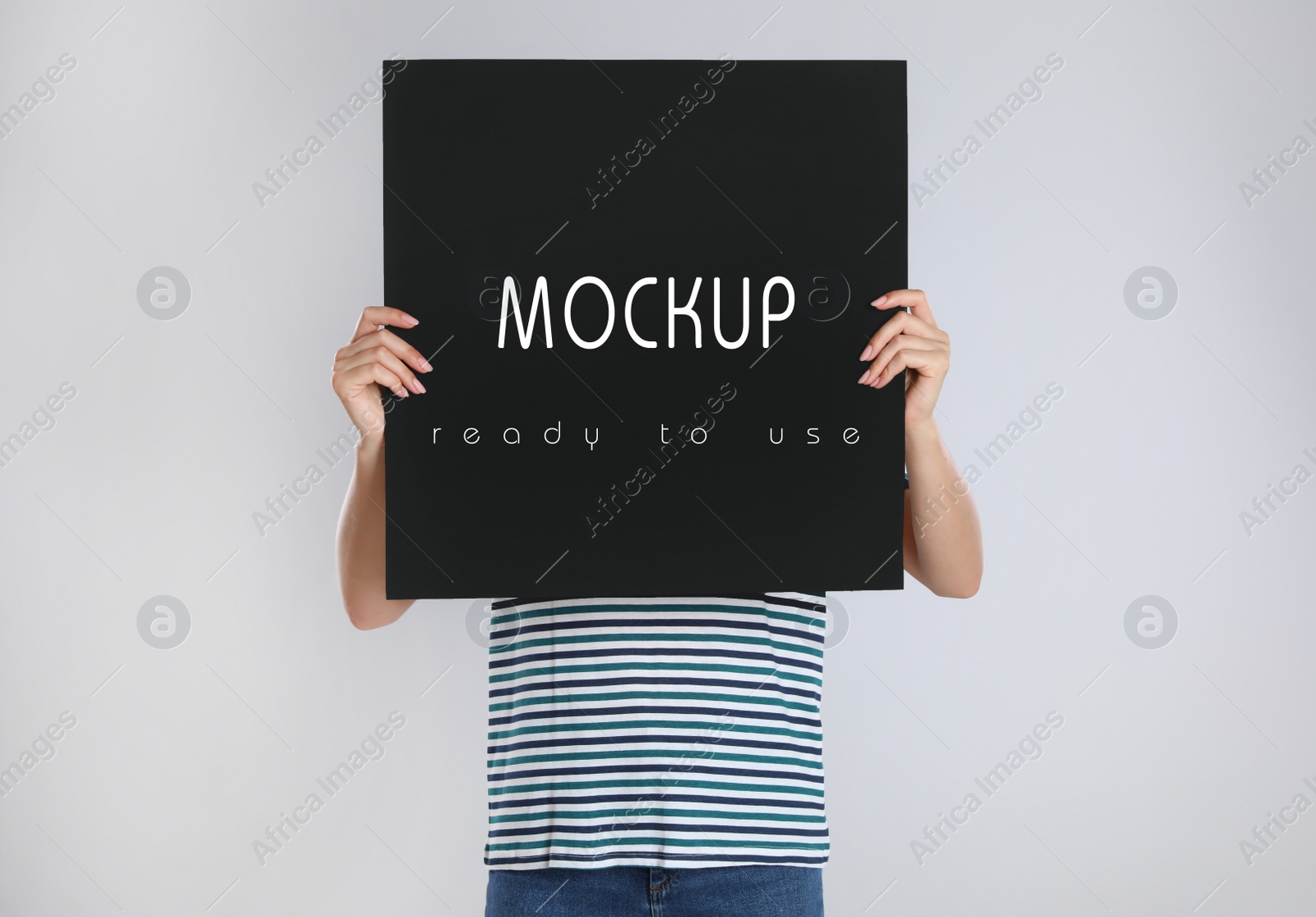 Image of Woman holding black poster with text Mockup Ready To Use on light background