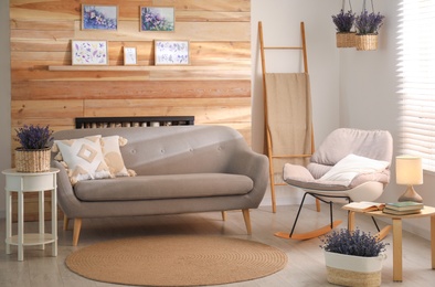 Photo of Stylish sofa and rocking chair in beautiful living room interior