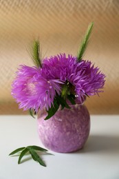 Photo of Bouquet of beautiful wildflowers in vase on light table