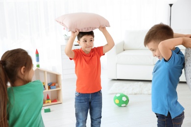 Photo of Cute little children playing together, indoors
