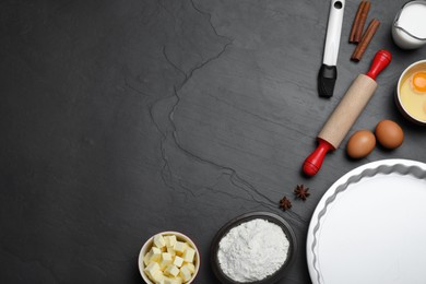 Photo of Cooking utensils and ingredients on black table, flat lay. Space for text