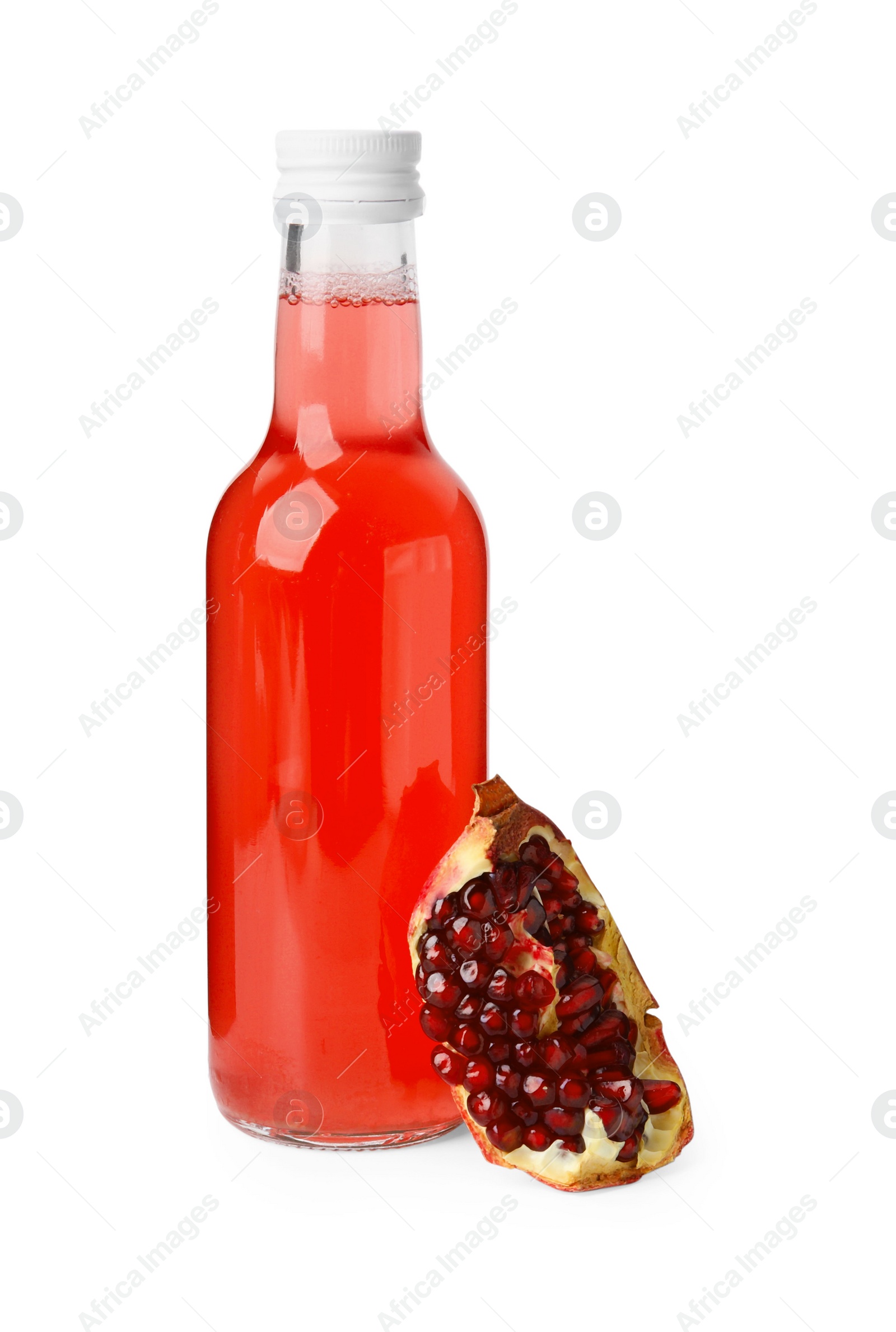 Photo of Delicious kombucha in glass bottle and pomegranate isolated on white