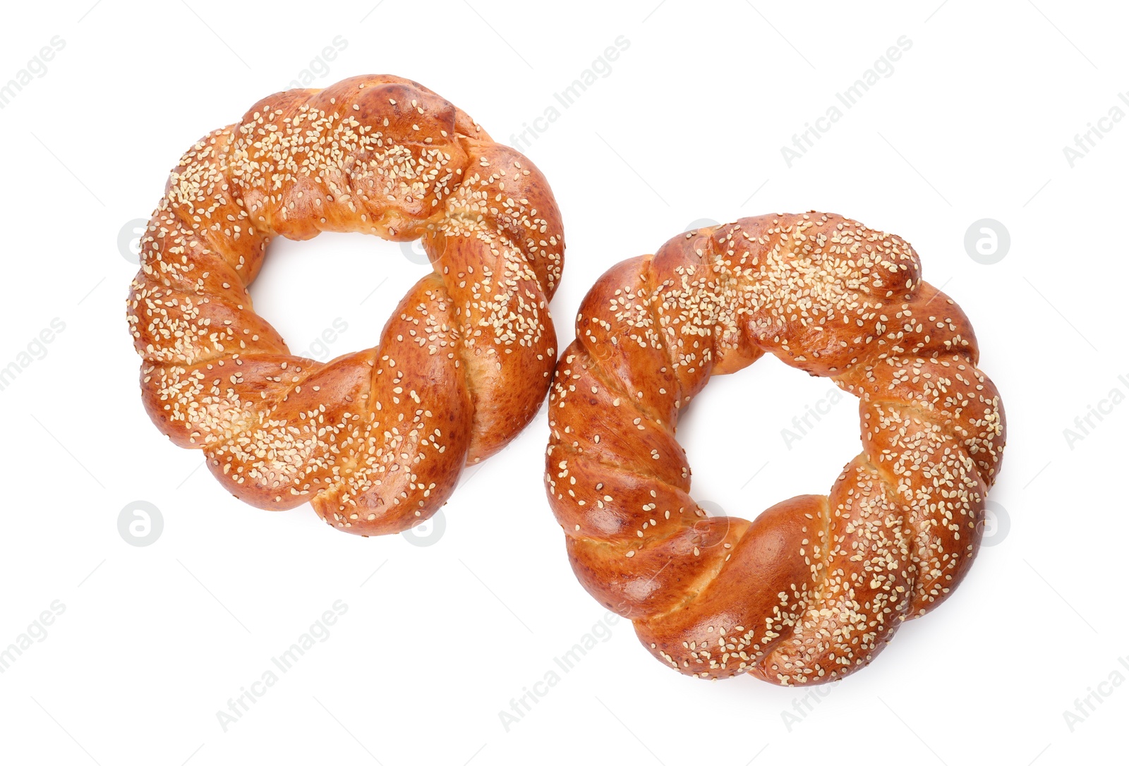 Photo of Round braided breads isolated on white, top view. Fresh pastries