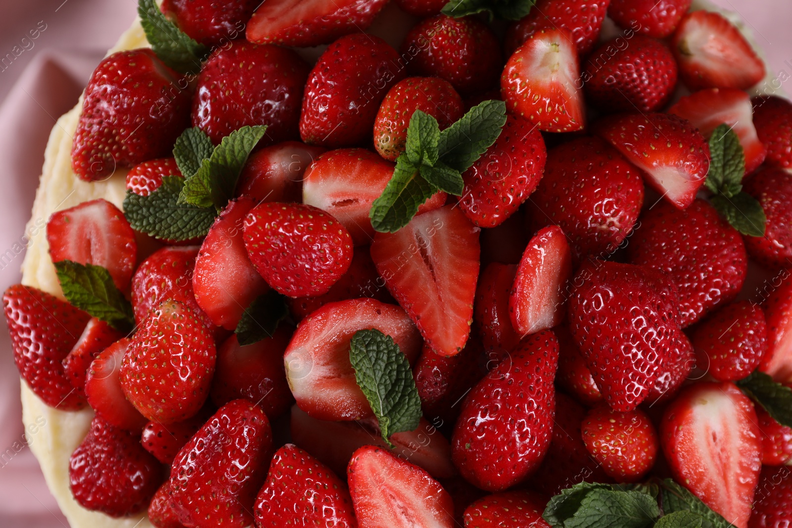 Photo of Many ripe strawberries and mint on light background, top view