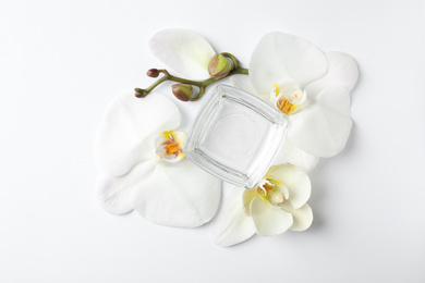 Composition with cosmetic gel and beautiful flowers on white background, top view