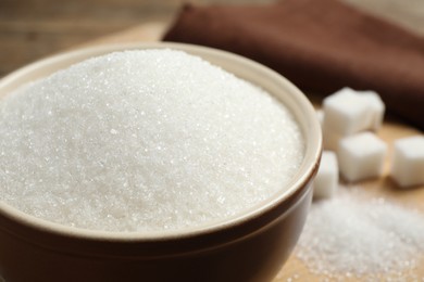 Granulated sugar in bowl on table, closeup