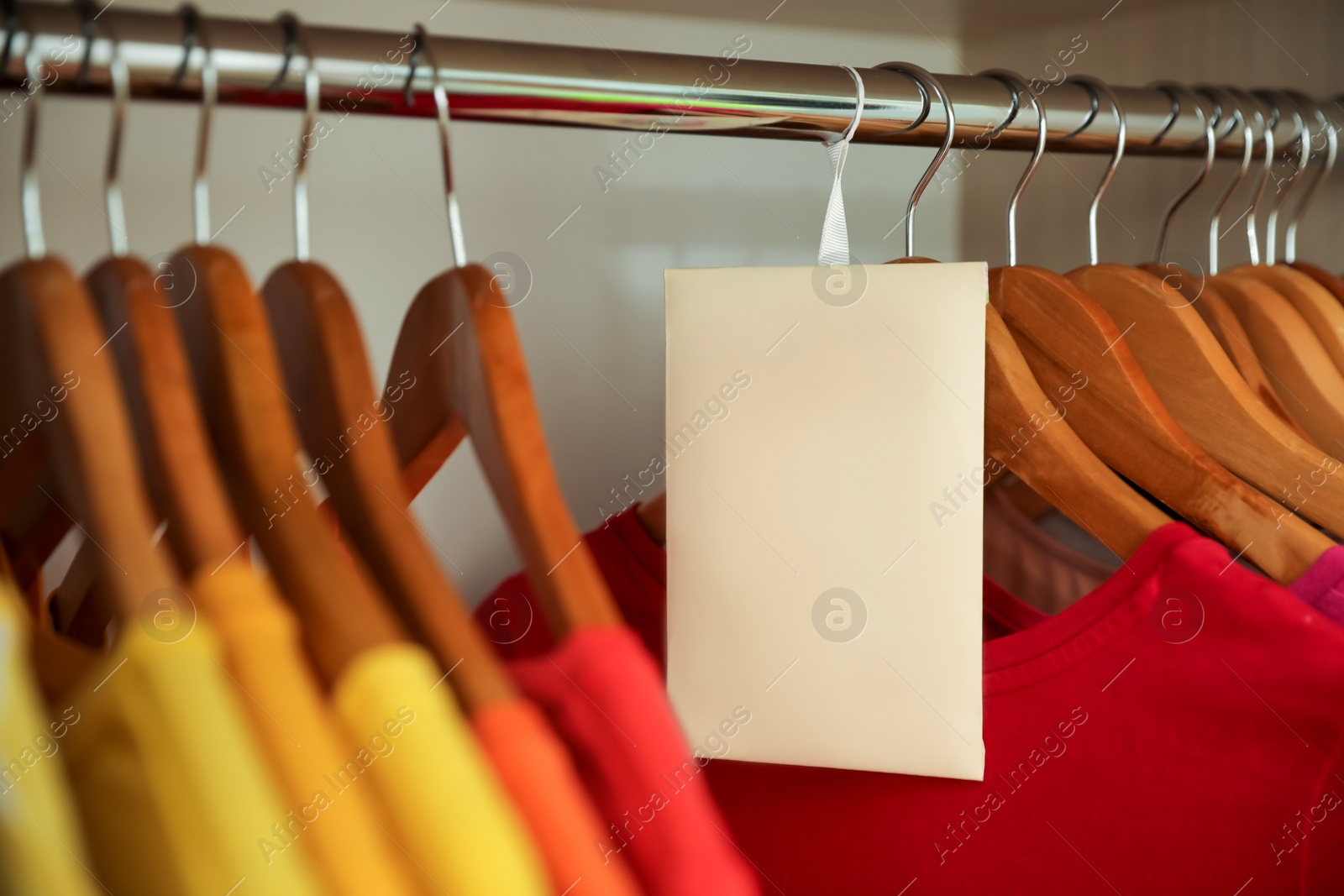 Photo of Scented sachet and clothes hanging in wardrobe