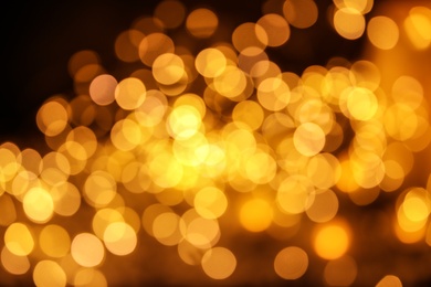 Photo of Gold glitter with bokeh effect on dark background