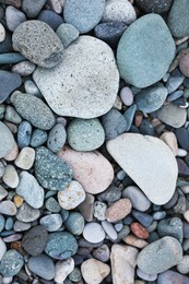 Many different pebbles as background, top view