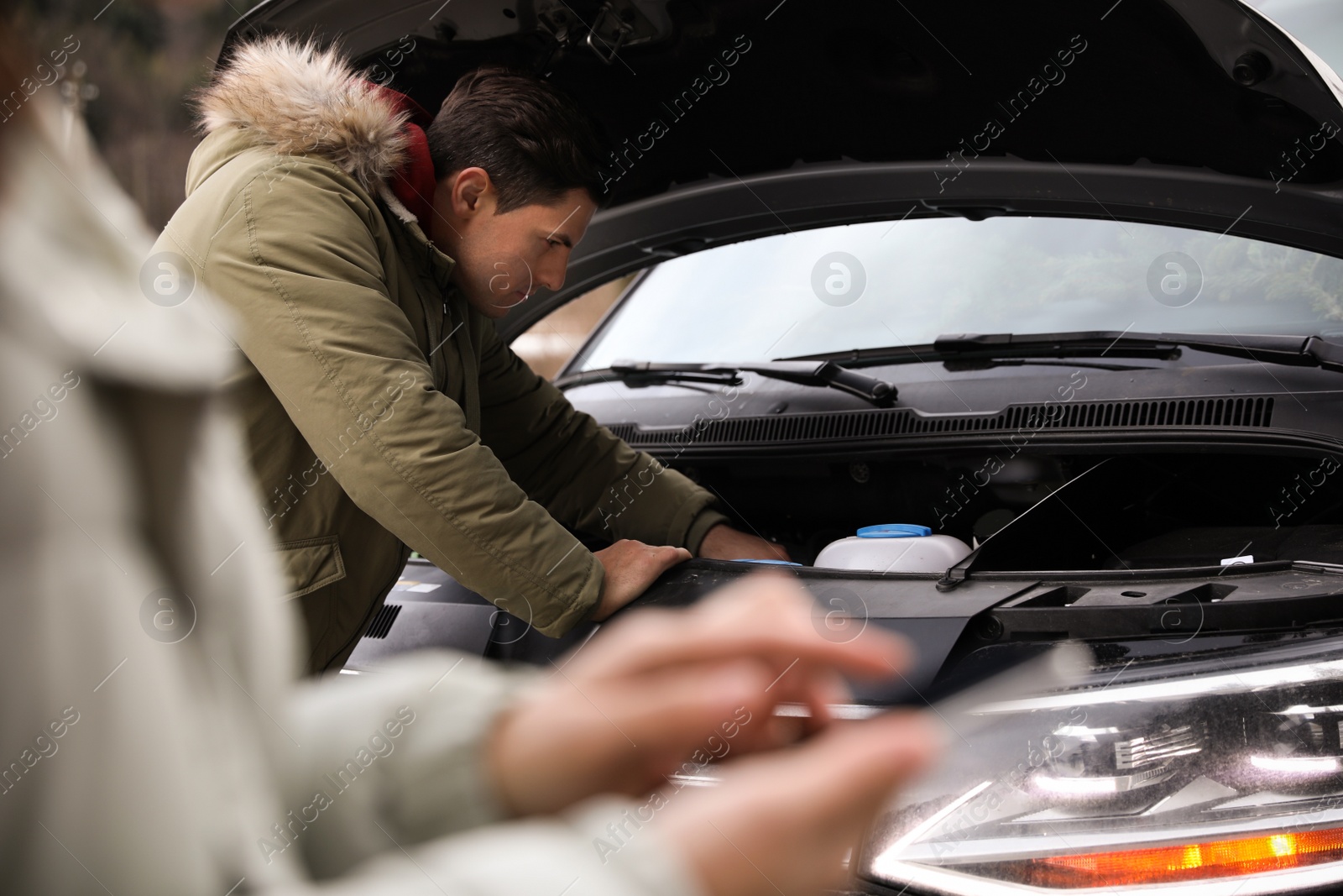 Photo of Stressed man near broken car outdoors on winter day