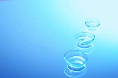 Contact lenses on color glass background