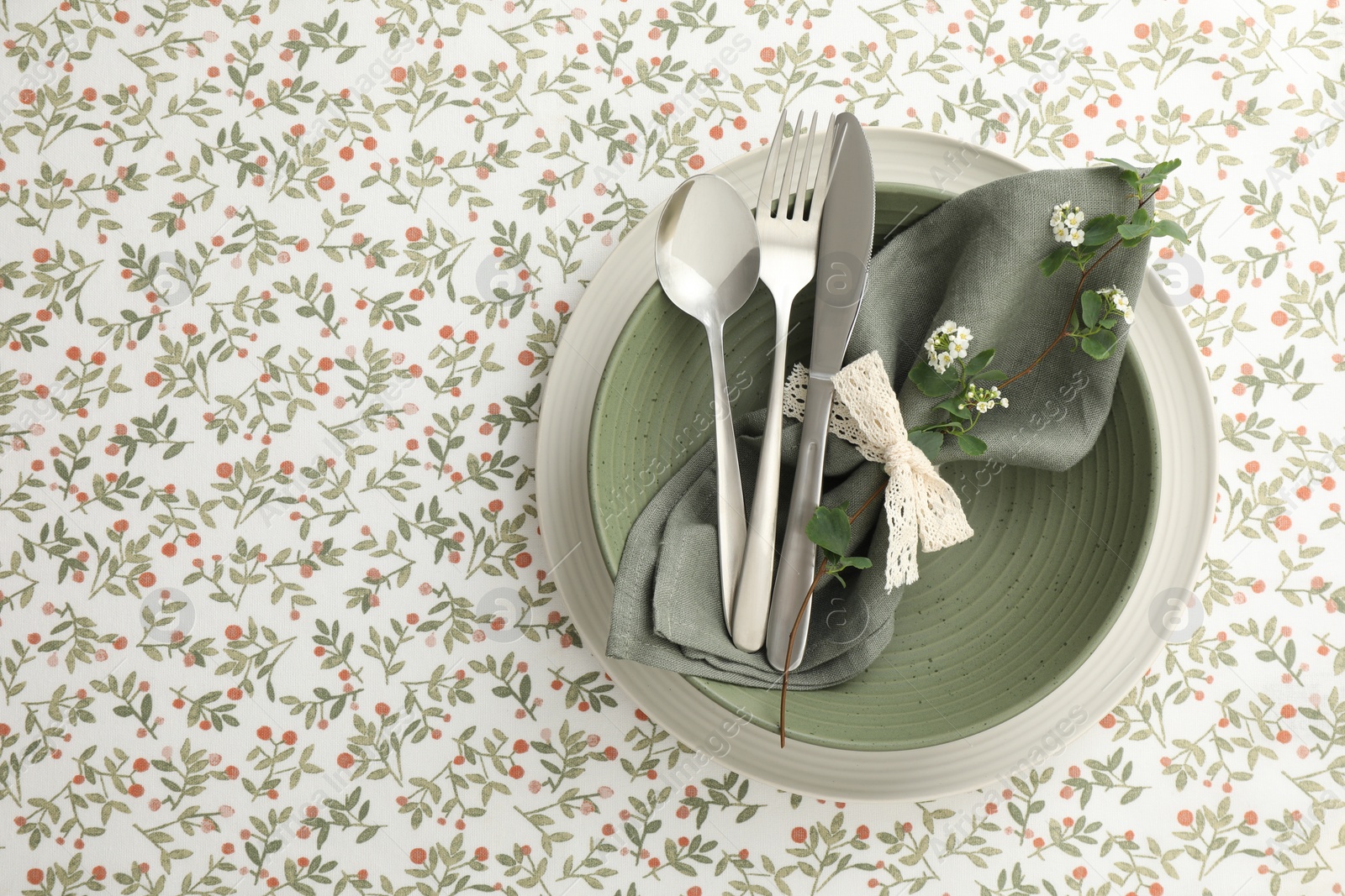 Photo of Stylish setting with cutlery, plates, napkin and floral decor on table, top view. Space for text