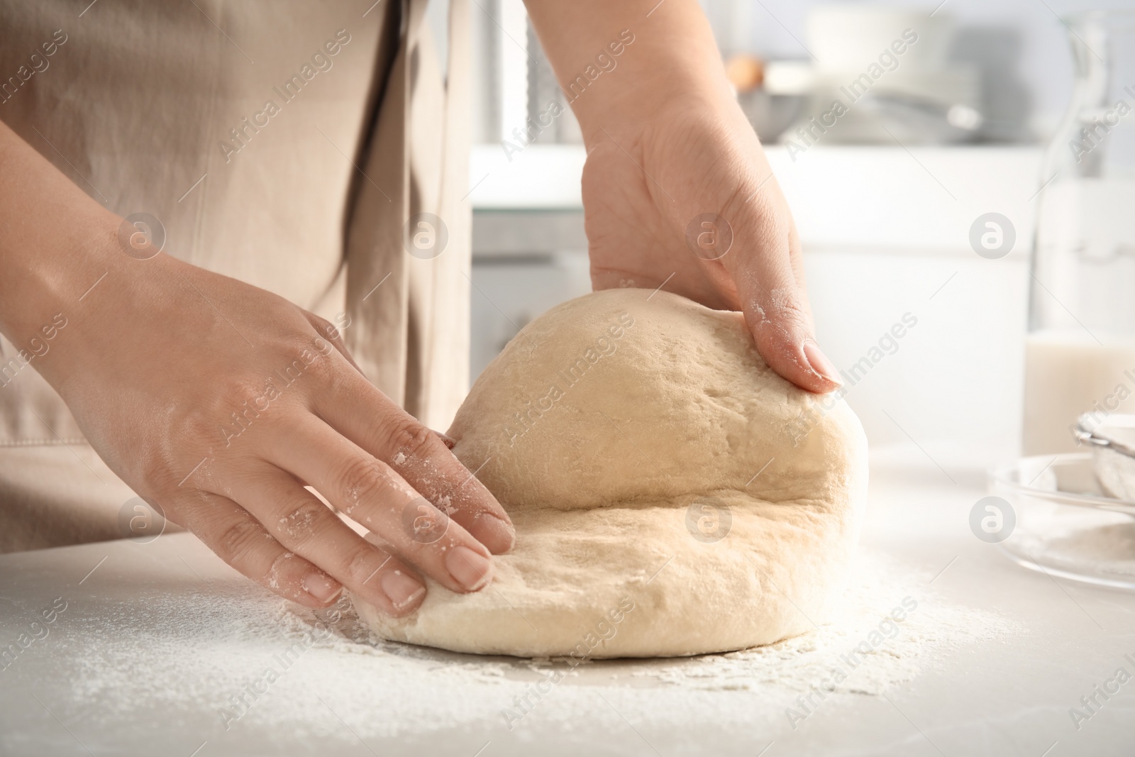 Photo of Woman kneading dough for pastry on table