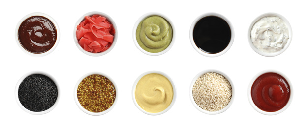 Set of different delicious sauces and condiments on white background, top view. Banner design