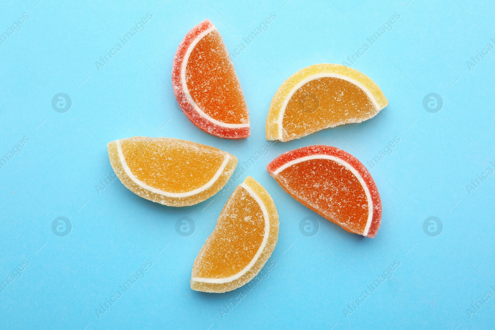 Photo of Tasty jelly candies on color background, flat lay