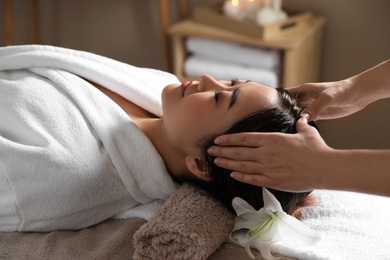 Photo of Beautiful Asian woman getting head massage in spa salon