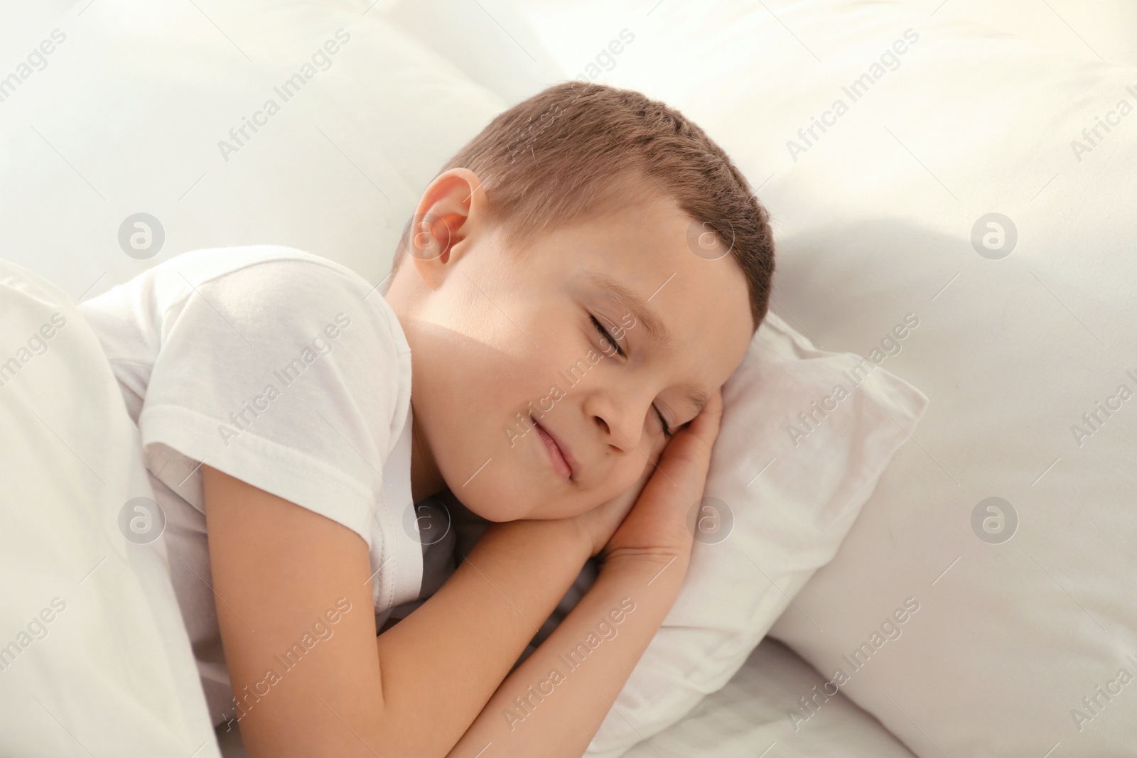 Photo of Cute little boy sleeping in bed at home