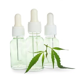 Photo of Bottles of hemp cosmetics with green leaves isolated on white