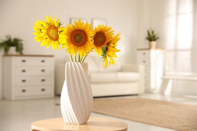 Photo of Bouquet of beautiful sunflowers in vase on table indoors. Space for text