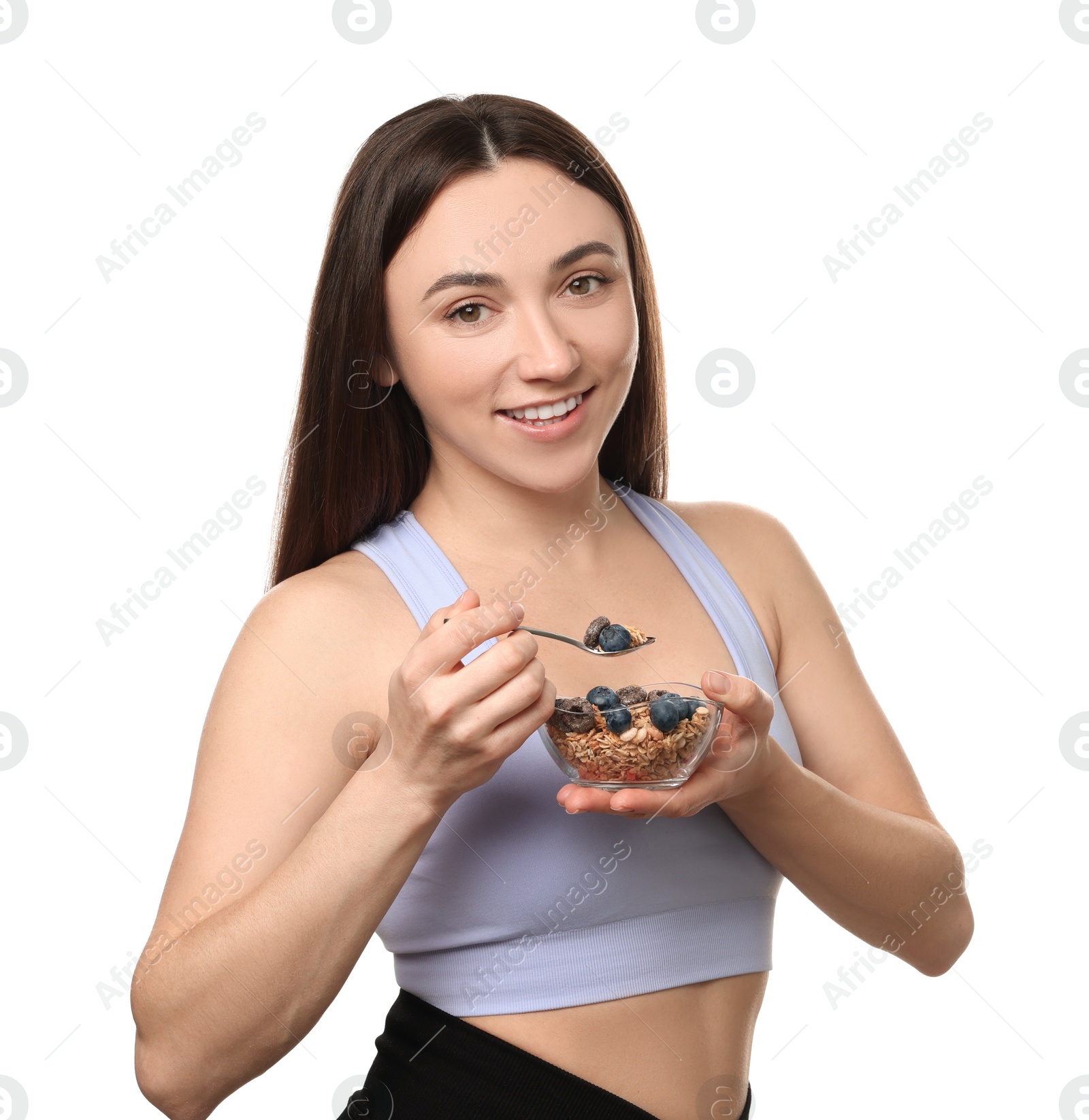 Photo of Happy woman eating tasty granola with fresh berries on white background