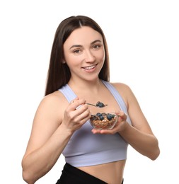 Happy woman eating tasty granola with fresh berries on white background