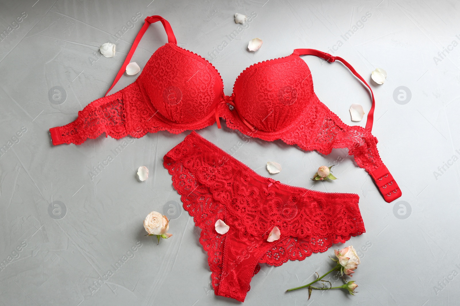 Photo of Sexy women's underwear and flowers on light background, flat lay