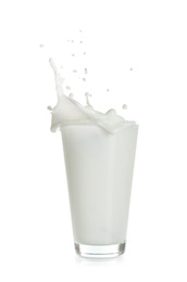 Photo of Milk splashing out of glass isolated on white
