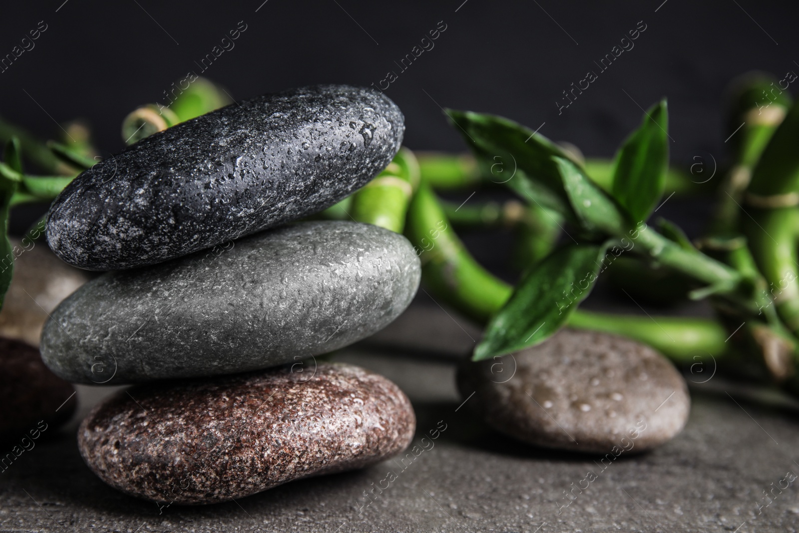 Photo of Composition with stones and bamboo on table. Zen concept