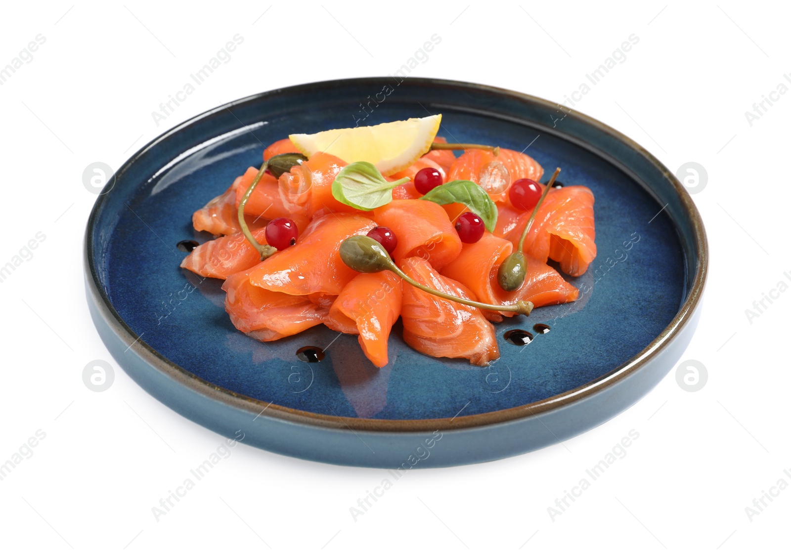 Photo of Salmon carpaccio with capers, cranberries, basil and lemon isolated on white