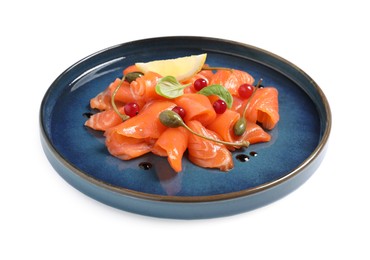 Photo of Salmon carpaccio with capers, cranberries, basil and lemon isolated on white