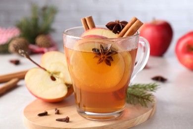 Photo of Aromatic hot mulled cider on light grey marble table