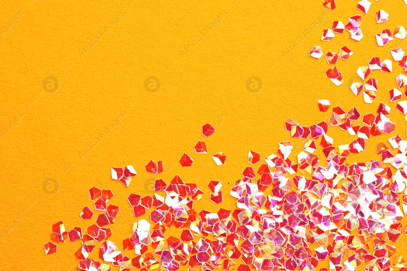 Photo of Pile of shiny glitter on orange background, flat lay. Space for text