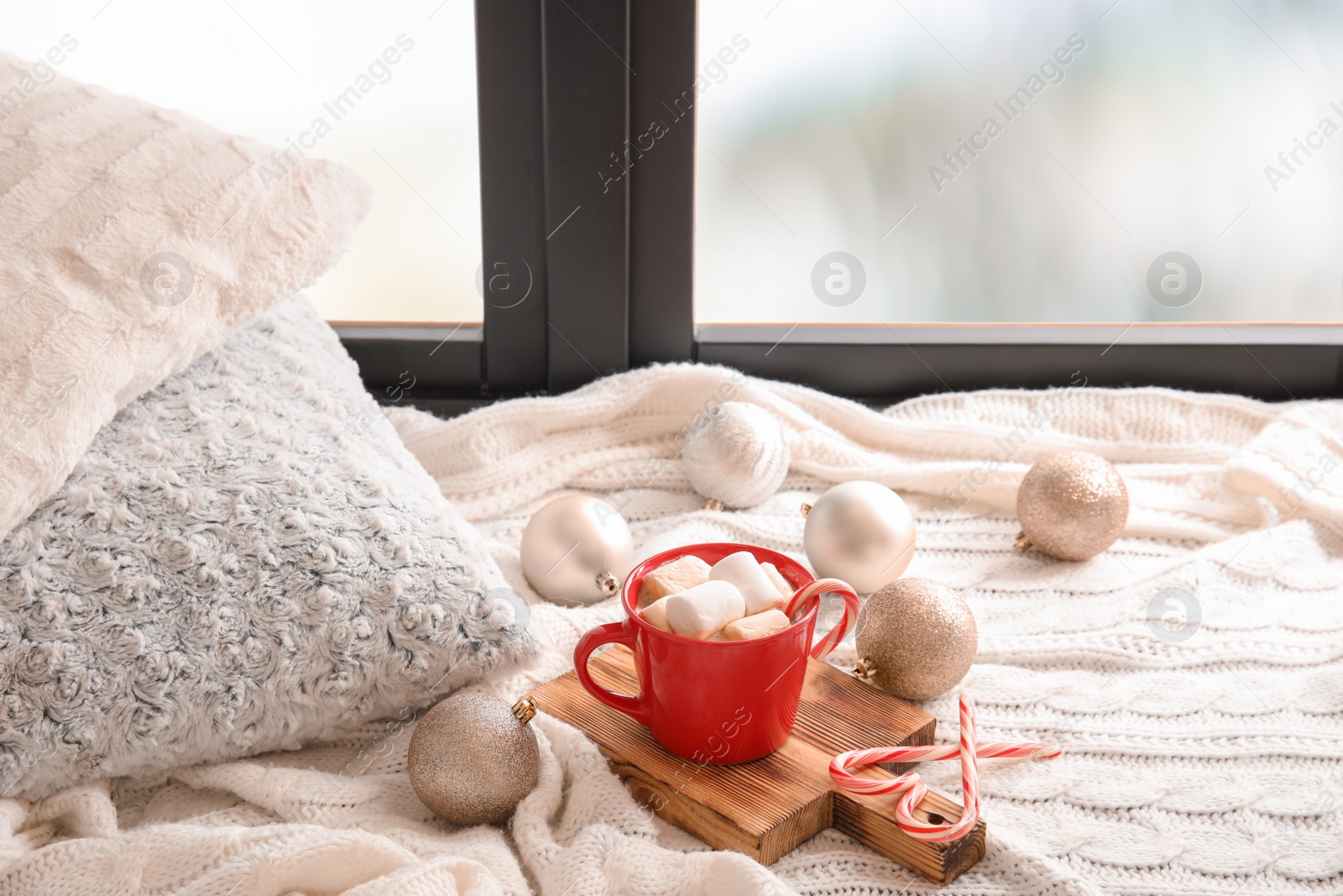 Photo of Composition with cup of hot winter drink near window. Cozy season
