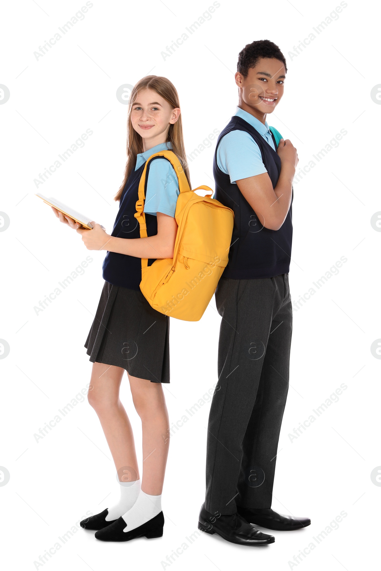 Photo of Full length portrait of teenagers in school uniform on white background