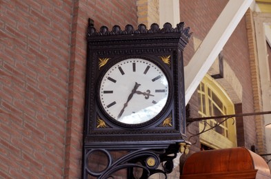 Beautiful black vintage clock on building outdoors