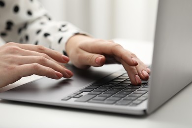 E-learning. Woman using laptop during online lesson at table indoors, closeup