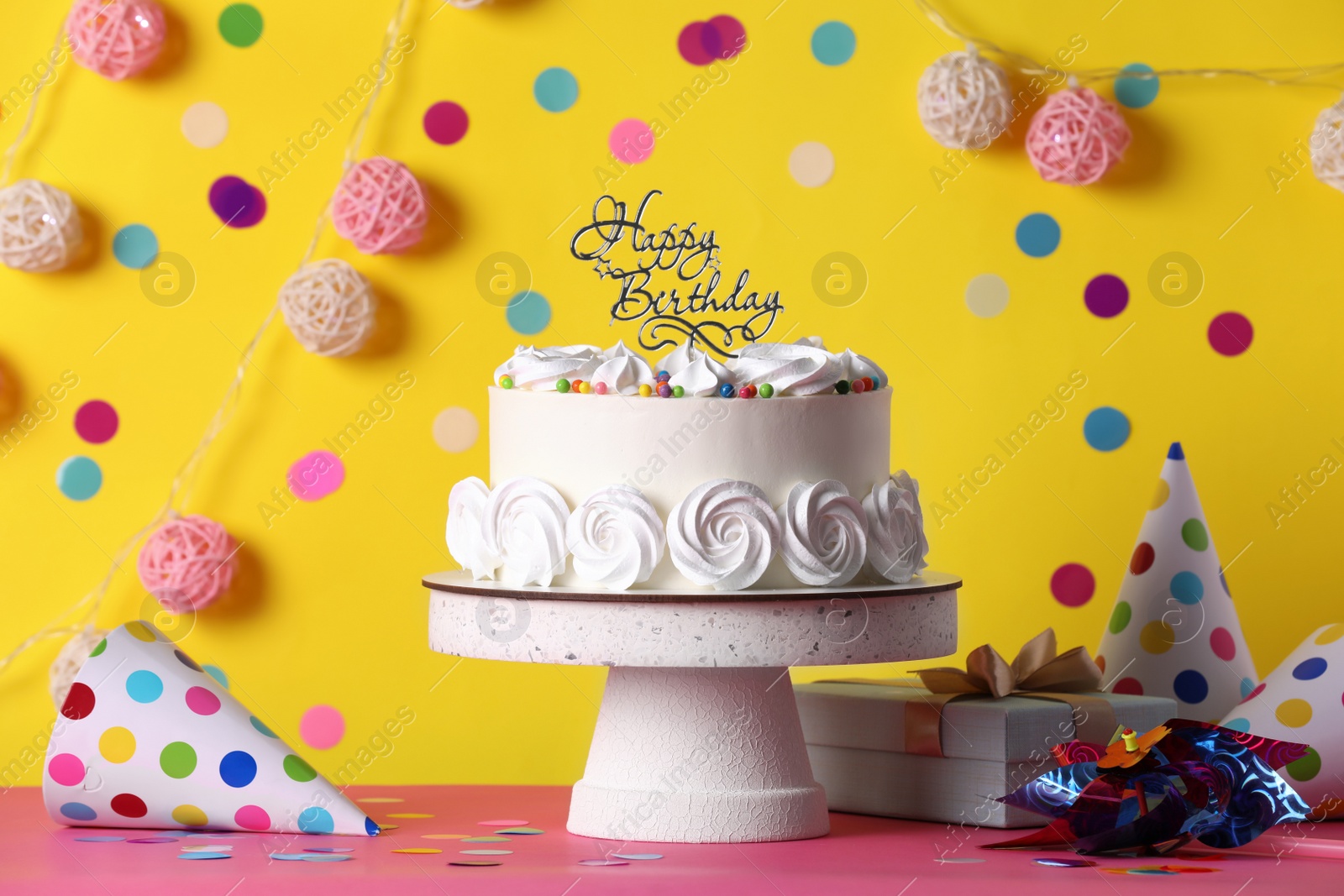 Photo of Beautiful birthday cake and decor on pink table