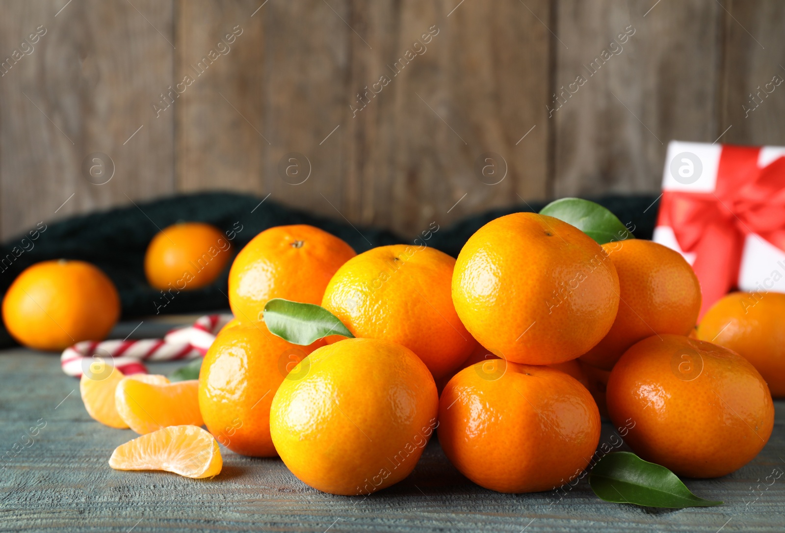 Photo of Tasty fresh tangerines on blue wooden table. Christmas celebration