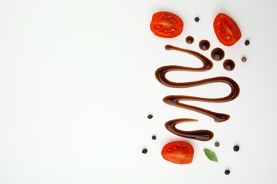 Organic balsamic vinegar and cooking ingredients on white background, flat lay. Space for text