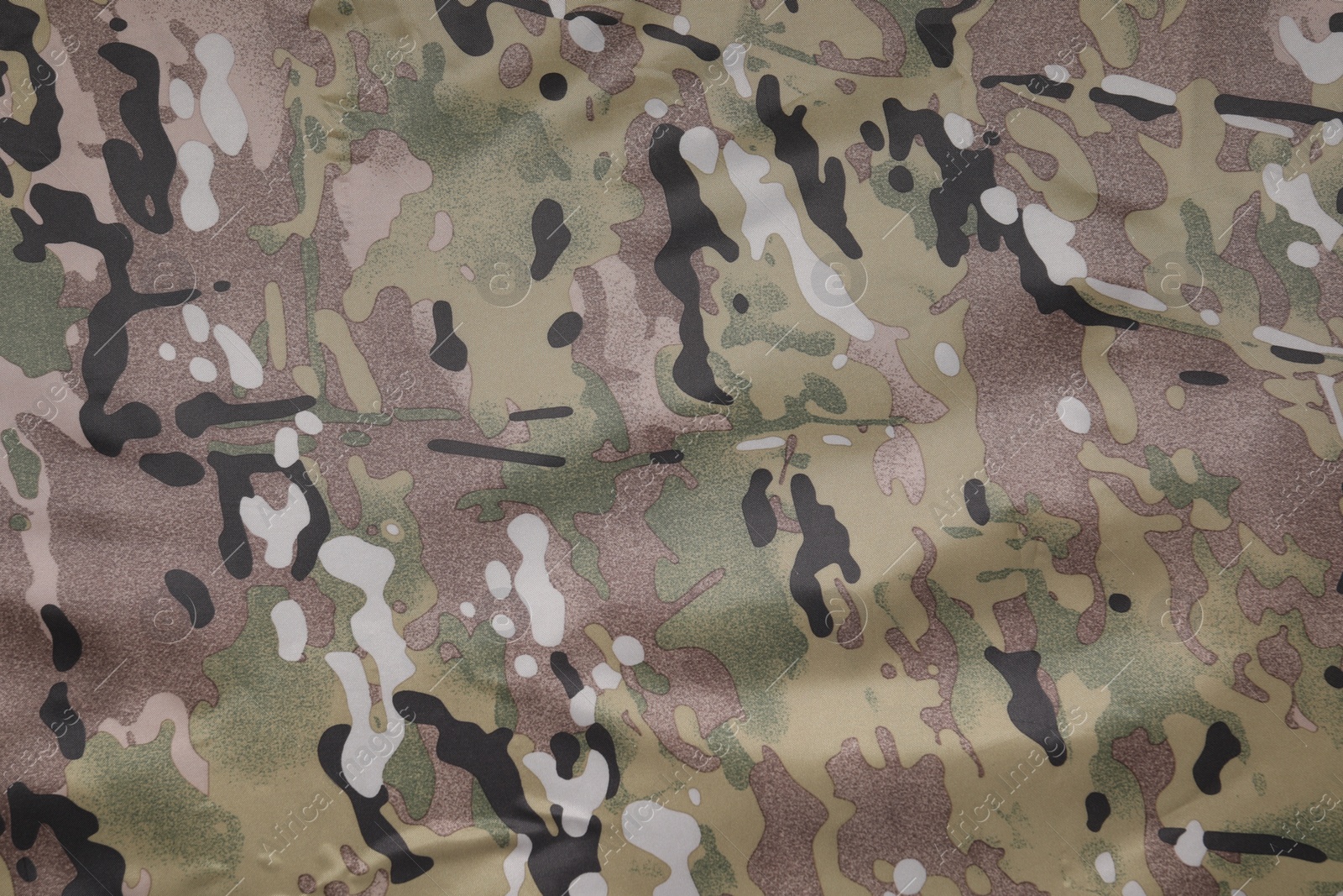 Photo of Texture of camouflage fabric as background, top view