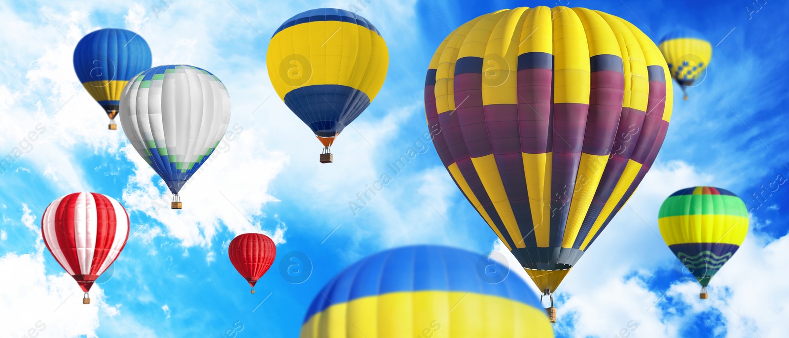 Image of Many bright hot air balloons flying in sky, banner design