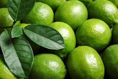 Photo of Fresh ripe green limes as background, closeup