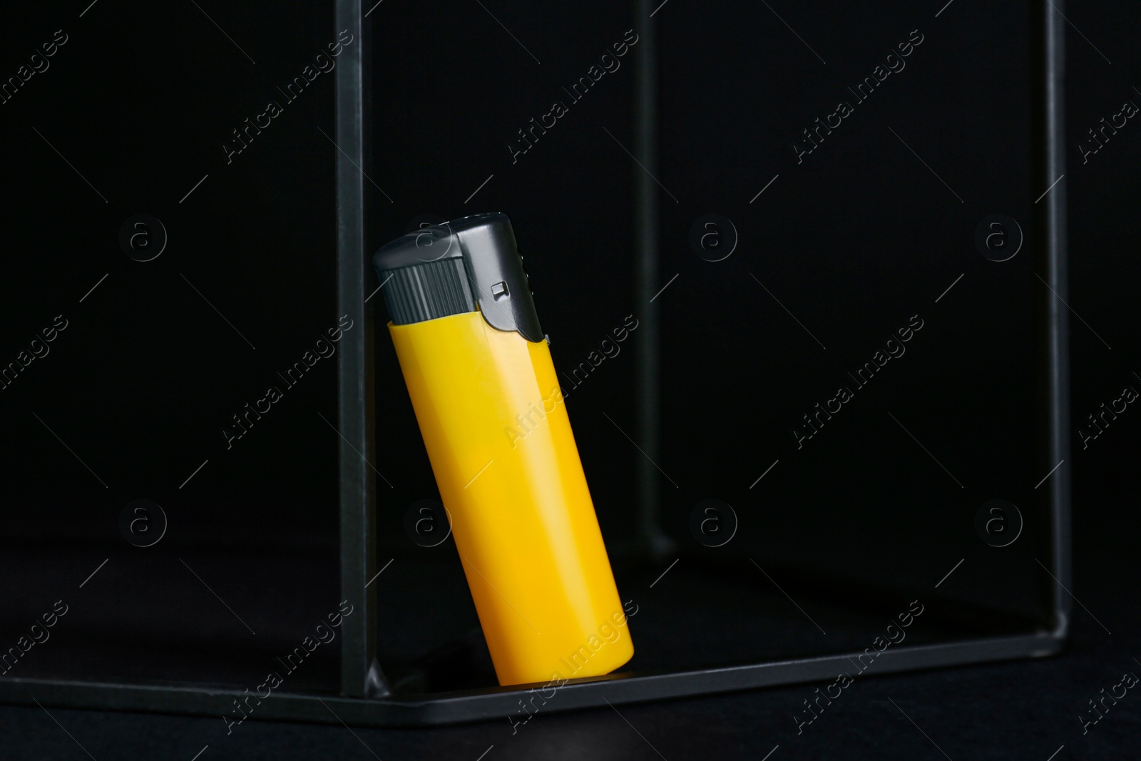 Photo of Stylish presentation of small pocket lighter on black background