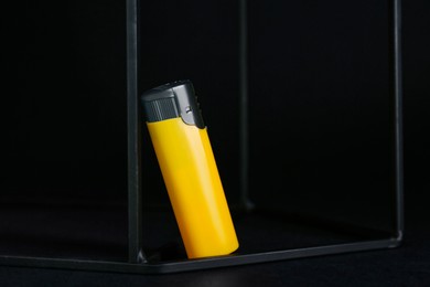 Photo of Stylish presentation of small pocket lighter on black background