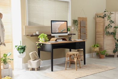 Light room interior with comfortable workplace near window