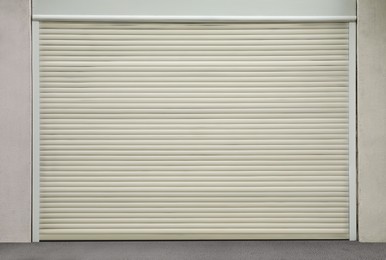 Photo of Building with white roller shutter garage door