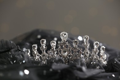 Beautiful silver tiara with diamonds on dark cloth